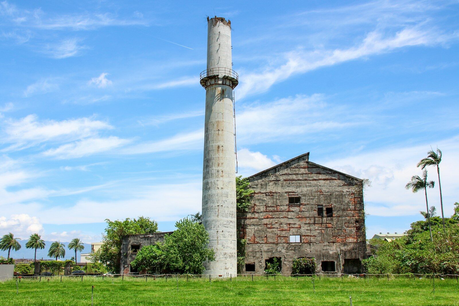 an old building with a tower in the middle of a field